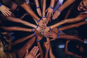 You are not alone. diverse people stacking hands together